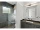 Modern bathroom with gray tile shower, floating vanity, and sleek black fixtures at 3740 Powers Ferry Nw Rd, Atlanta, GA 30342
