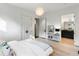 Light-filled bedroom with white walls, wood floors, and door leading to bathroom at 3740 Powers Ferry Nw Rd, Atlanta, GA 30342