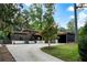Beautiful single-story home featuring a long driveway, mature trees, and a modern design at 3740 Powers Ferry Nw Rd, Atlanta, GA 30342