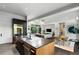 Open kitchen showcases a gray countertop island and stainless steel appliances, seamlessly flowing into the living and dining areas at 3740 Powers Ferry Nw Rd, Atlanta, GA 30342
