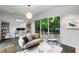 Living room with backyard views, desk space, comfortable seating, and modern decor at 3740 Powers Ferry Nw Rd, Atlanta, GA 30342