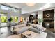 Bright open-concept living space with high ceilings, modern furnishings, and a bar area with black tile and beverage cooler at 3740 Powers Ferry Nw Rd, Atlanta, GA 30342