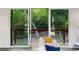 Living room with floor to ceiling glass doors offering a view of the private backyard at 3740 Powers Ferry Nw Rd, Atlanta, GA 30342