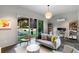 Bright living room with modern furniture, a backyard view, and a stylish lighting fixture at 3740 Powers Ferry Nw Rd, Atlanta, GA 30342