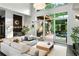 Bright living room featuring a large sectional couch, modern fixtures, and sliding glass doors to the deck at 3740 Powers Ferry Nw Rd, Atlanta, GA 30342