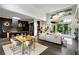Open-concept living room with modern design, high ceilings, and seamless flow to the kitchen and outdoor views at 3740 Powers Ferry Nw Rd, Atlanta, GA 30342