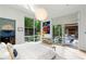 Sun-filled primary bedroom with large windows, deck access, and an ensuite bathroom at 3740 Powers Ferry Nw Rd, Atlanta, GA 30342