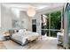 A stylish bedroom with a large window that offers outdoor views and a light wood floor at 3740 Powers Ferry Nw Rd, Atlanta, GA 30342