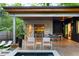Beautiful outdoor space featuring a wooden deck with dining area, an outdoor kitchen, and a view of the modern home at 3740 Powers Ferry Nw Rd, Atlanta, GA 30342