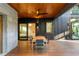 Outdoor patio with dark wood features a dining set, stone accents, and a ceiling fan at 3740 Powers Ferry Nw Rd, Atlanta, GA 30342