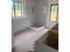 Unfinished bathroom showcasing a walk-in shower with tiled walls and two windows at 933 Mount Carmel Church Ln, Canton, GA 30114