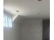 Unfinished bedroom with white walls and a large window at 933 Mount Carmel Church Ln, Canton, GA 30114