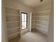 Unfinished closet with white shelving and a window at 933 Mount Carmel Church Ln, Canton, GA 30114