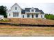New construction modern farmhouse-style home with a black roof and white siding on a hilltop lot at 933 Mount Carmel Church Ln, Canton, GA 30114