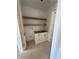 Pantry area with white cabinets, wood shelves, and unfinished countertops, offering ample storage at 933 Mount Carmel Church Ln, Canton, GA 30114