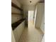 Pantry with white cabinets, open wood shelves, and decorative tile flooring, perfect for organization at 933 Mount Carmel Church Ln, Canton, GA 30114