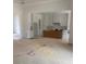 Open-concept kitchen with white cabinets, stainless appliances, and unfinished countertops at 933 Mount Carmel Church Ln, Canton, GA 30114