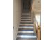 Unfinished staircase with wooden handrail and white steps, ready for personalization at 933 Mount Carmel Church Ln, Canton, GA 30114