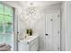 Well-lit bathroom with a modern lighting fixture and a vanity with under-cabinet storage at 1130 Angelo Ne Ct, Atlanta, GA 30319