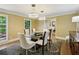 Elegant dining room featuring modern lighting fixtures and seating for six at 1130 Angelo Ne Ct, Atlanta, GA 30319