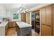 Contemporary kitchen featuring a large island, wine cooler, custom cabinets, and modern lighting at 1130 Angelo Ne Ct, Atlanta, GA 30319