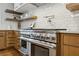 Gourmet kitchen featuring stainless steel appliances, custom cabinetry, and a tiled backsplash at 1130 Angelo Ne Ct, Atlanta, GA 30319