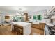 Bright kitchen with a center island, farm sink, open shelving, and hardwood flooring at 1130 Angelo Ne Ct, Atlanta, GA 30319