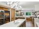 Open-concept kitchen with modern lighting, wine storage, and a center island with seating at 1130 Angelo Ne Ct, Atlanta, GA 30319