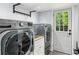Functional laundry room with modern washer and dryer, plus a convenient utility sink and backyard access at 1130 Angelo Ne Ct, Atlanta, GA 30319