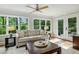 Bright living room with large windows, ceiling fan, and access to the outdoor deck at 1130 Angelo Ne Ct, Atlanta, GA 30319