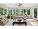 Bright living room featuring large windows, stylish furnishings, and hardwood floors at 1130 Angelo Ne Ct, Atlanta, GA 30319