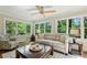 Sun-filled living room with large windows, a comfortable sofa, and a ceiling fan at 1130 Angelo Ne Ct, Atlanta, GA 30319