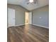 Spacious bedroom with ample natural light, beautiful hardwood floors, and standard door providing access to other rooms at 1295 Kilmington Ct, Alpharetta, GA 30009