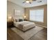 Inviting bedroom features a comfortable queen-sized bed, soft lighting, and large window, enhancing the calm ambiance at 1295 Kilmington Ct, Alpharetta, GA 30009