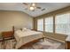 Cozy bedroom featuring a ceiling fan, multiple windows, and a comfortable bed, creating a serene atmosphere at 1295 Kilmington Ct, Alpharetta, GA 30009