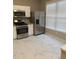 Bright kitchen with stainless steel appliances, white cabinets, and marble flooring at 1295 Kilmington Ct, Alpharetta, GA 30009
