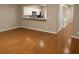 Open-concept living area featuring hardwood floors and a pass through to a full modern kitchen at 1295 Kilmington Ct, Alpharetta, GA 30009