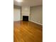 Cozy living room features hardwood floors and a fireplace at 1295 Kilmington Ct, Alpharetta, GA 30009