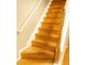 Elegant staircase featuring wooden steps and a white handrail, seamlessly connecting the different levels of the home at 1295 Kilmington Ct, Alpharetta, GA 30009