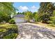 Home with a long driveway, a two-car garage, and green, manicured landscaping at 401 Azalea Cv, Canton, GA 30114
