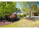 Charming single-story home surrounded by lush landscaping and mature trees at 401 Azalea Cv, Canton, GA 30114