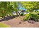 Inviting single-story home with mature trees and manicured landscaping on a sunny day at 401 Azalea Cv, Canton, GA 30114