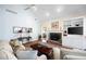 Living room with a fireplace, built-in shelving, a ceiling fan, and ample seating at 401 Azalea Cv, Canton, GA 30114