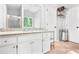 Bright bathroom features a granite-topped vanity with white cabinets, a large mirror, and modern fixtures at 9955 Rivertown Rd, Fairburn, GA 30213