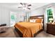 Comfortable bedroom featuring a large bed, ceiling fan, and views of the outdoors at 9955 Rivertown Rd, Fairburn, GA 30213
