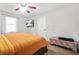 Bedroom with bed, patterned storage bench, and window views at 9955 Rivertown Rd, Fairburn, GA 30213
