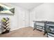 Neutral bedroom showcasing desk, printer, TV and bookcase with books and carpeted floor at 9955 Rivertown Rd, Fairburn, GA 30213