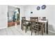 Inviting dining area with wood table, chairs, and view into the cozy living room with fireplace at 9955 Rivertown Rd, Fairburn, GA 30213