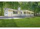 Exterior view of home showcasing the attached garage, siding, and landscaped yard on a sunny day at 9955 Rivertown Rd, Fairburn, GA 30213