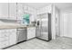 Modern kitchen featuring stainless steel appliances, granite counters and ample white cabinetry at 9955 Rivertown Rd, Fairburn, GA 30213